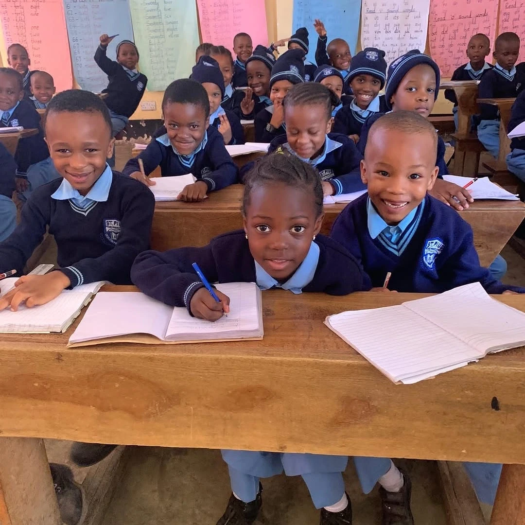 Smiling students at St. Pius Primary School in Arusha, supported by Gundua Africa's 10% profit donation.